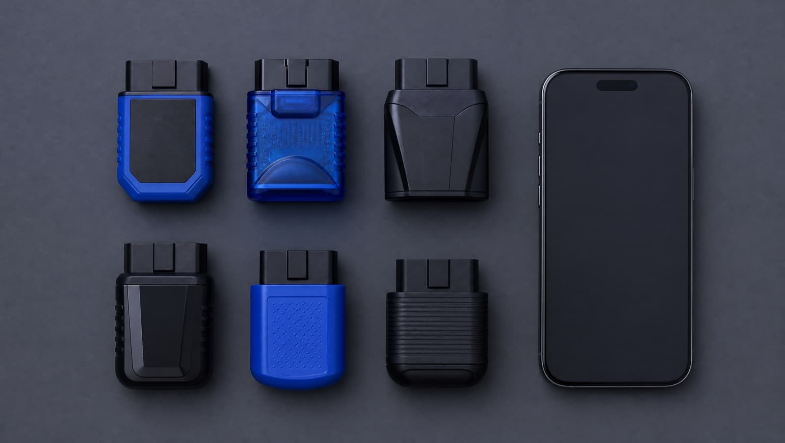 A selection of Bluetooth OBD-II adapters and an iPhone on a table