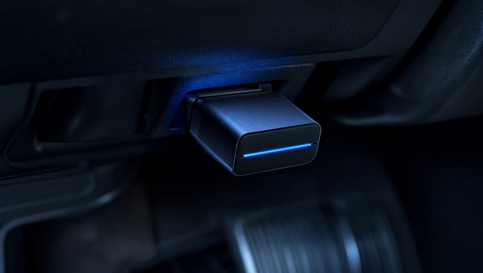 A Bluetooth OBD-II adapter plugged into a car's diagnostic port