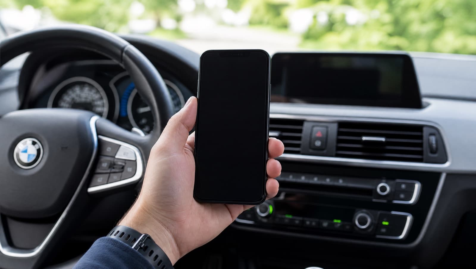 An iPhone running AutoMalaya OBD held inside a car