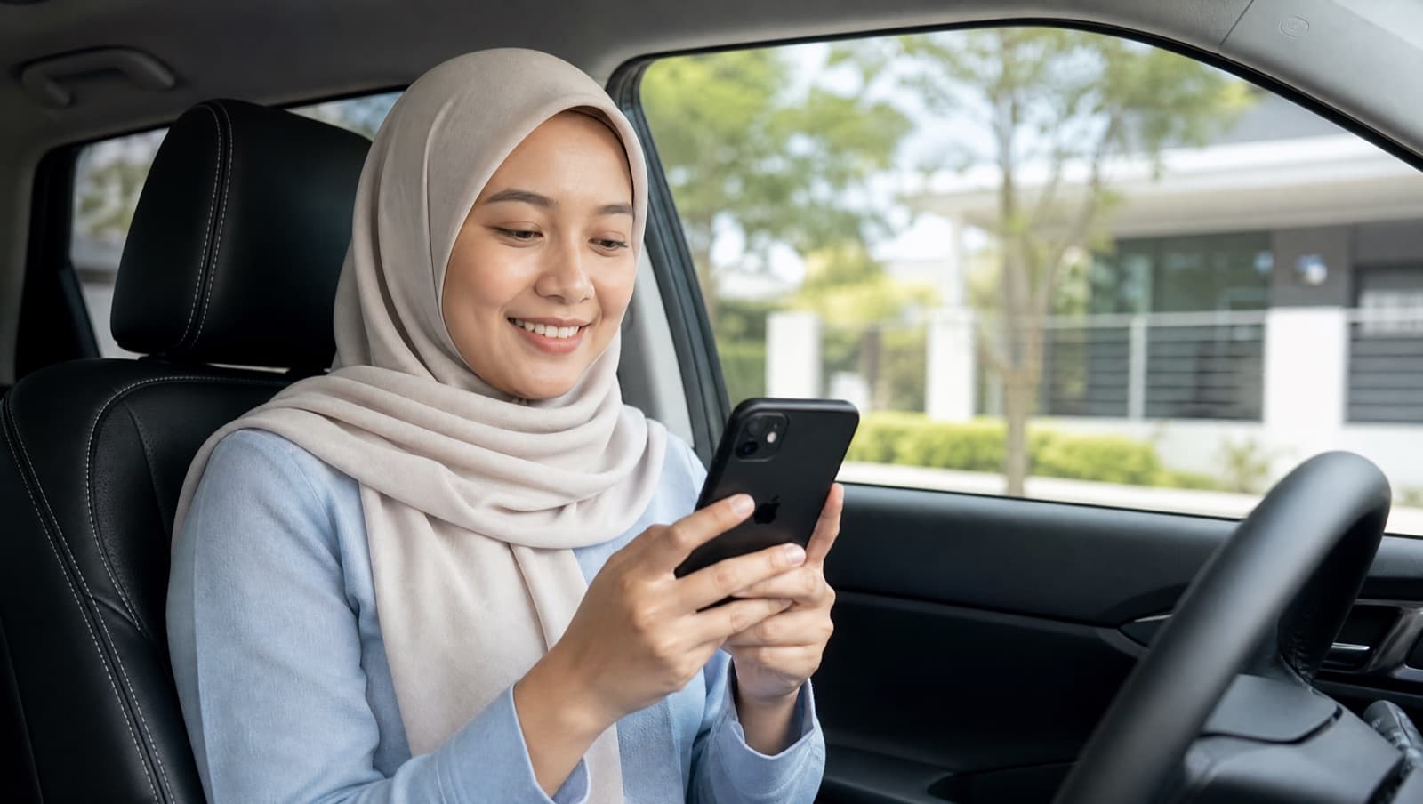 A driver smiling while checking her car's health on an iPhone